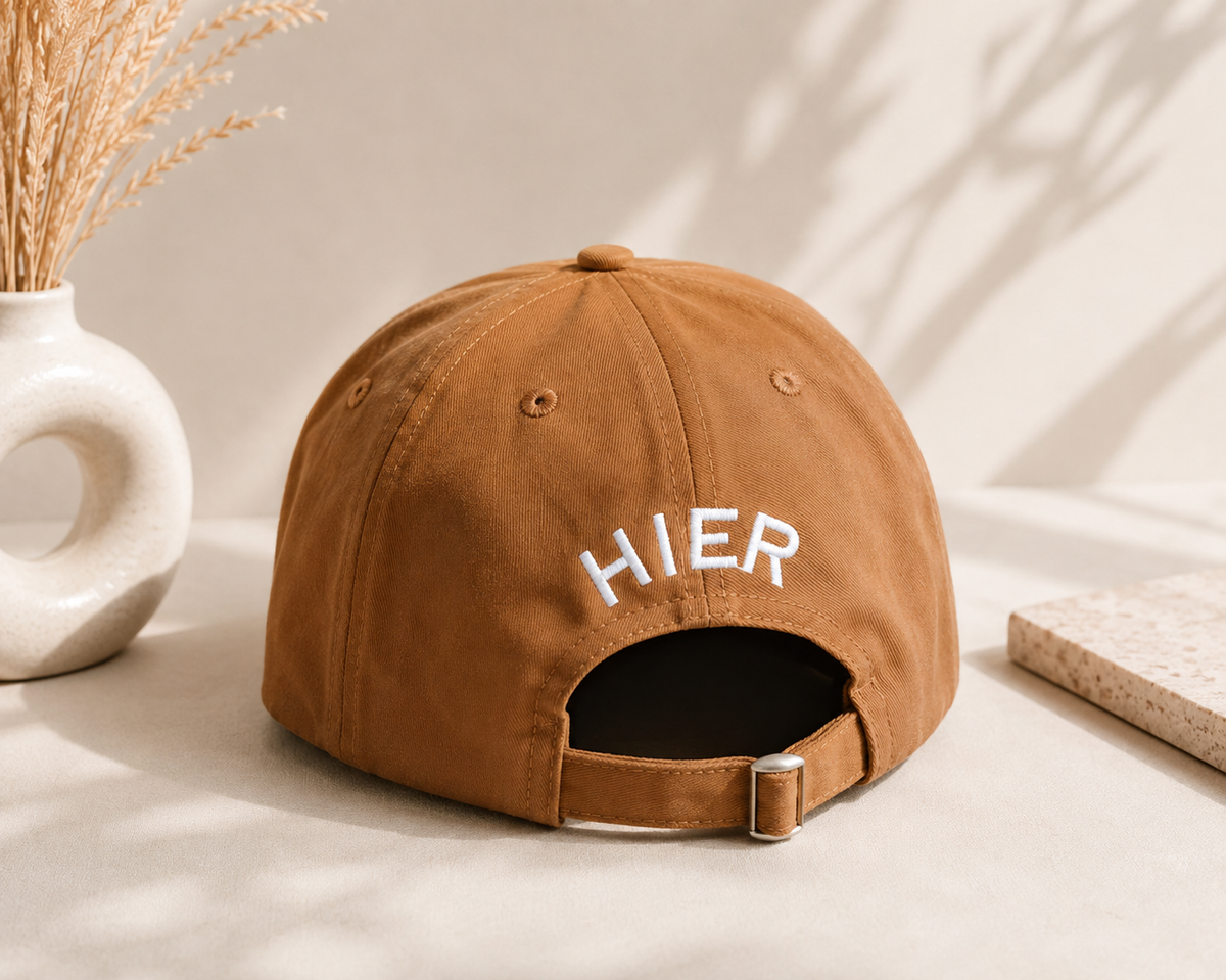Brown embroidered baseball cap with HIER logo and adjustable back strap