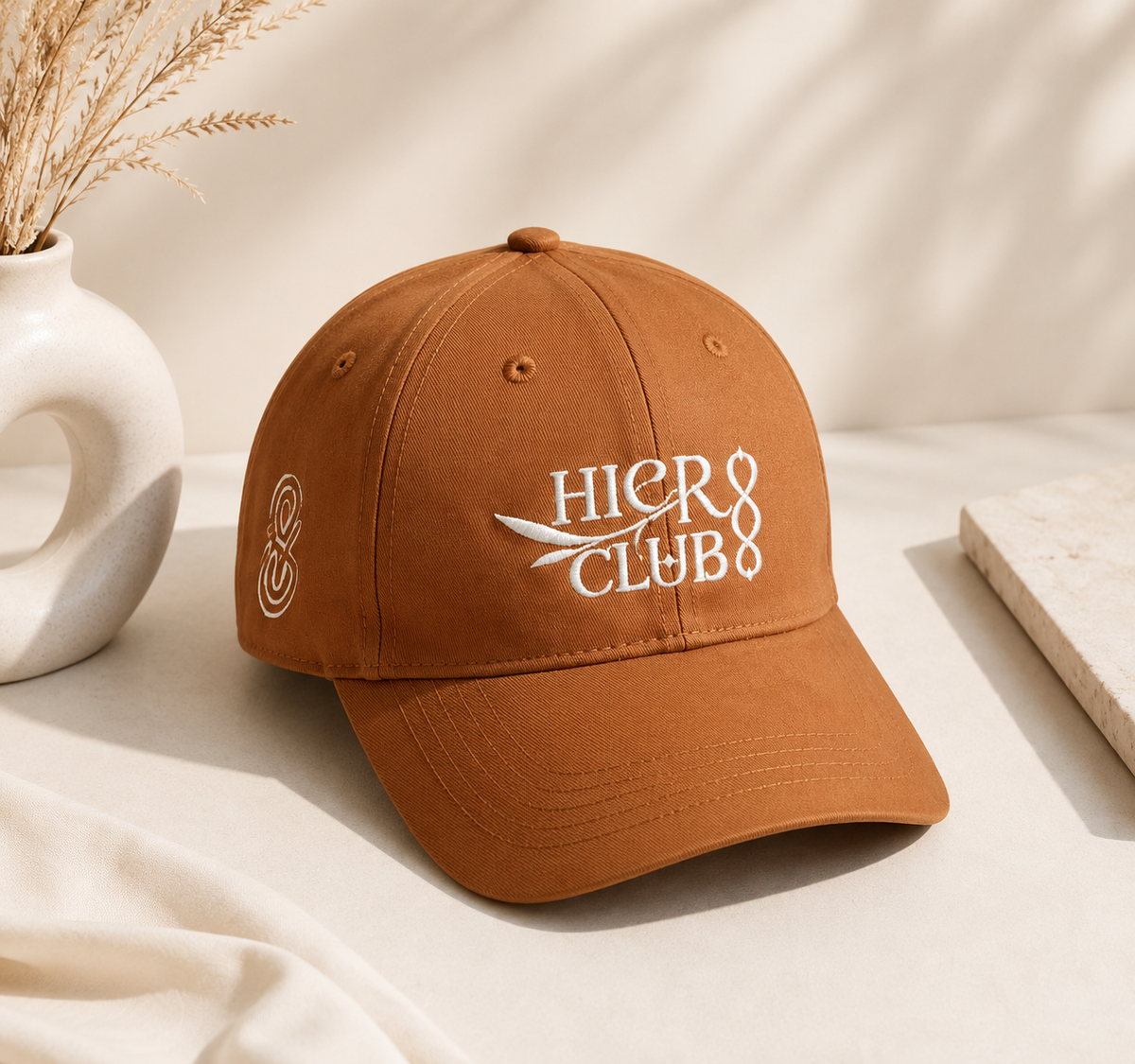Brown embroidered baseball cap with HIER CLUB logo and monogram detail