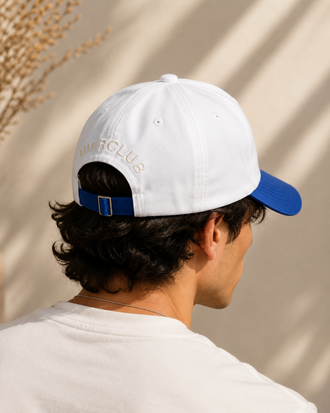 White and blue embroidered baseball cap with HIER CLUB logo, back view